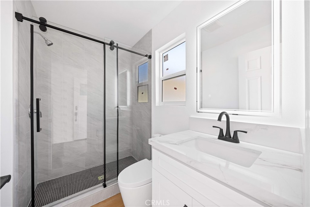 2274 Cogswell Road El Monte, CA 91732 - Photo 16 of 26 a bathroom with a shower sink vanity mirror and toilet