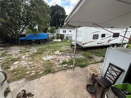 a view of a chairs and table in the patio