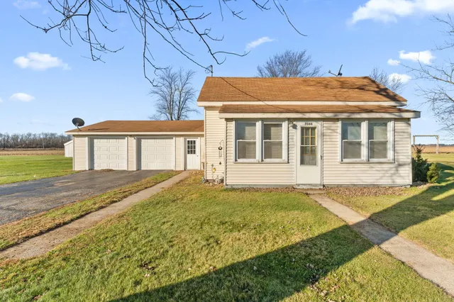 a view of a house with pool and a yard