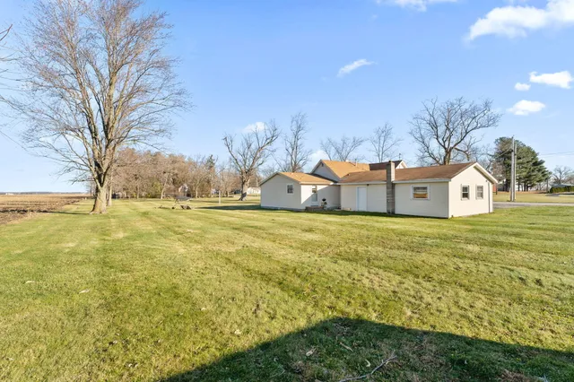 a house view with swimming pool in front of it