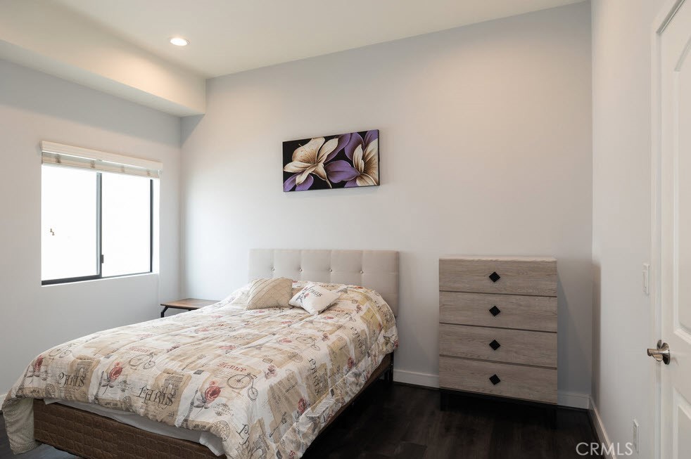 2651 South Hobart Boulevard, Unit 9 Los Angeles, CA 90018 - Photo 2 of 8 a bedroom with a bed and a window