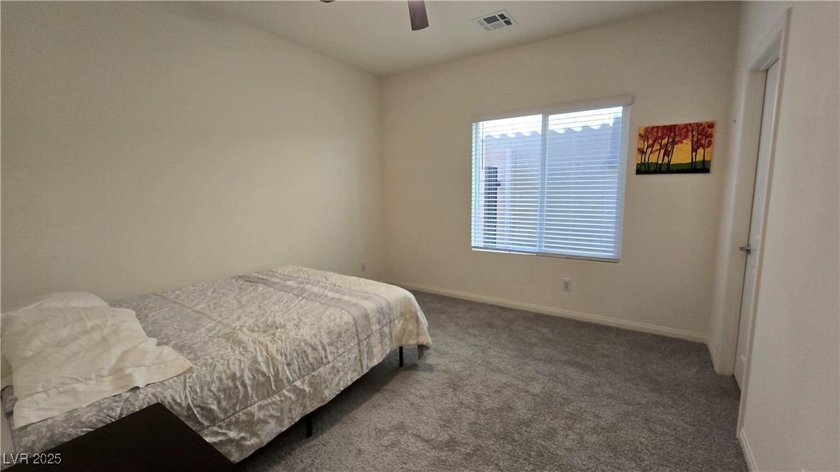 10971 Meridian Fields Avenue Las Vegas, NV 89166 - Photo 14 of 66 Carpeted bedroom with baseboards and ceiling fan
