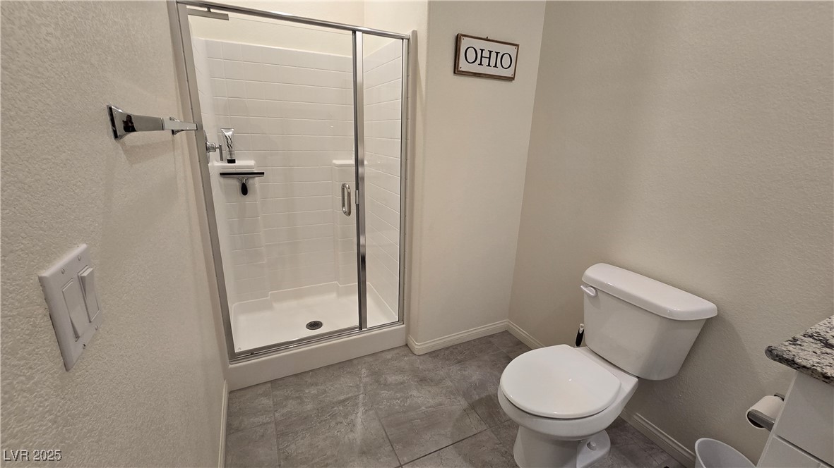 10971 Meridian Fields Avenue Las Vegas, NV 89166 - Photo 16 of 66 Bathroom featuring a textured wall, a shower stall, and vanity