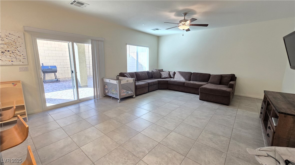 10971 Meridian Fields Avenue Las Vegas, NV 89166 - Photo 29 of 66 Living room featuring light tile patterned flooring and a ceiling fan