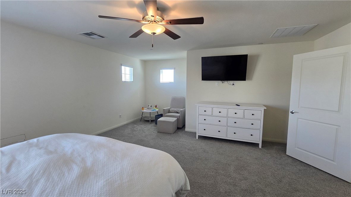 10971 Meridian Fields Avenue Las Vegas, NV 89166 - Photo 33 of 66 Carpeted bedroom with ceiling fan and baseboards