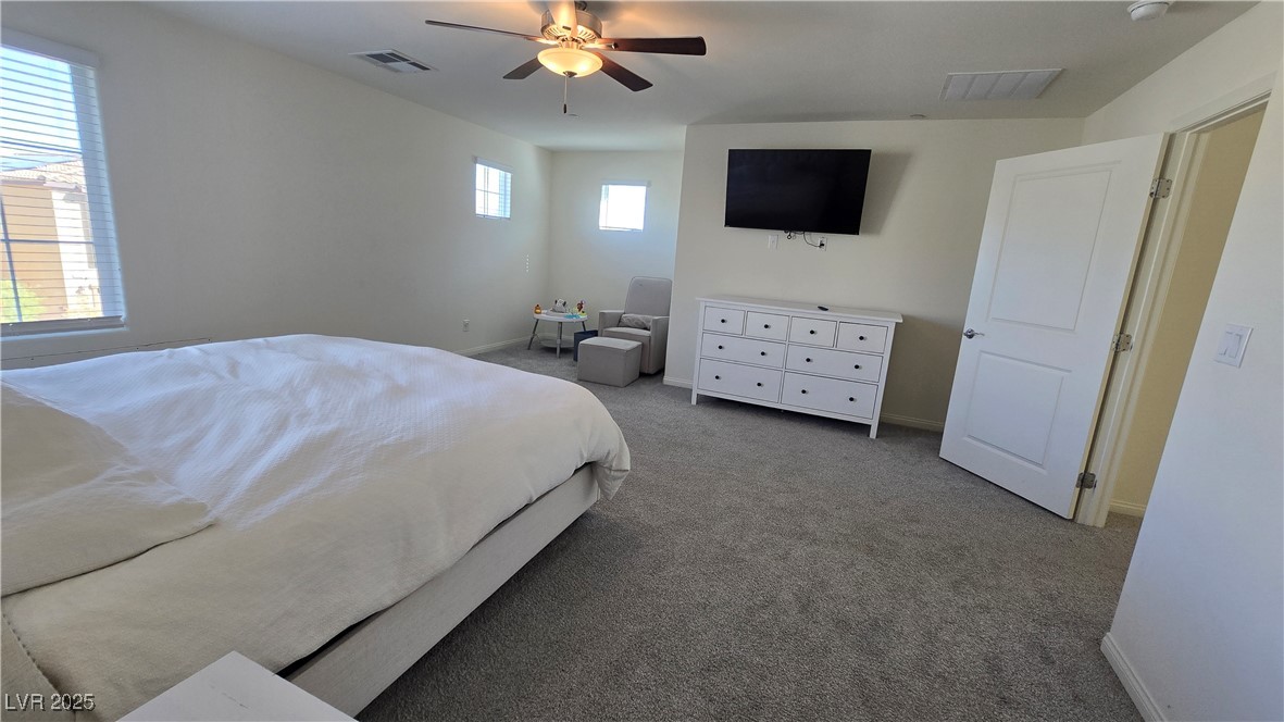 10971 Meridian Fields Avenue Las Vegas, NV 89166 - Photo 34 of 66 Carpeted bedroom featuring ceiling fan and baseboards