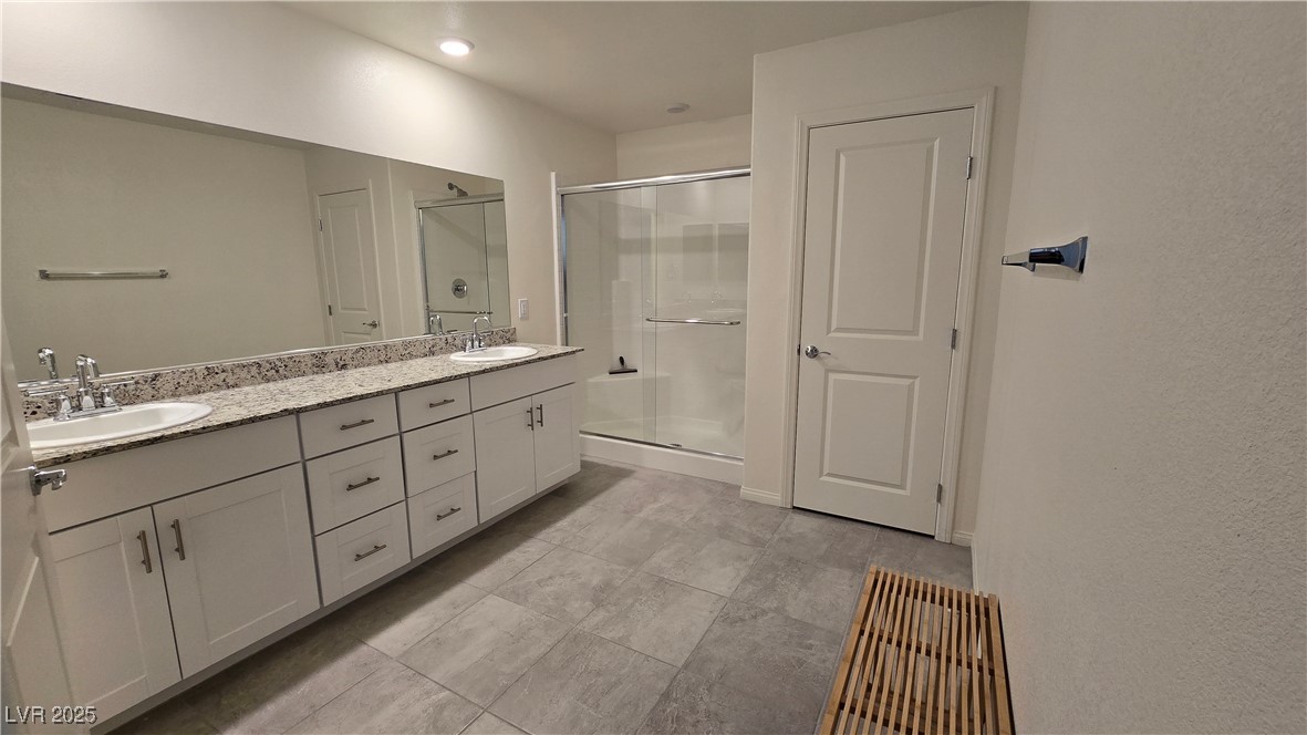 10971 Meridian Fields Avenue Las Vegas, NV 89166 - Photo 35 of 66 Bathroom with double vanity and a shower stall