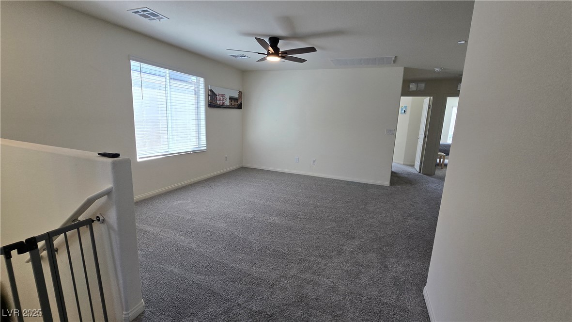 10971 Meridian Fields Avenue Las Vegas, NV 89166 - Photo 38 of 66 Carpeted empty room featuring baseboards and ceiling fan