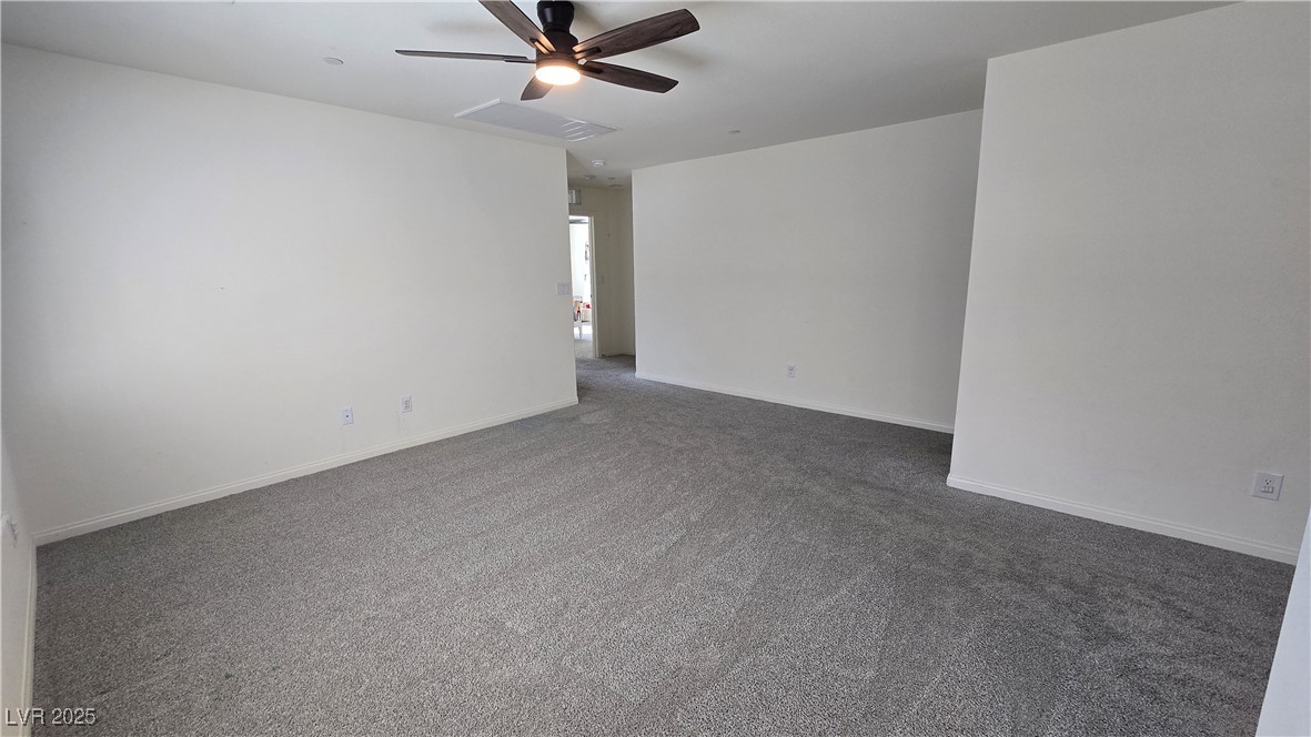 10971 Meridian Fields Avenue Las Vegas, NV 89166 - Photo 40 of 66 Empty room featuring carpet and ceiling fan