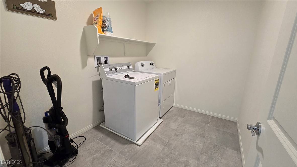 10971 Meridian Fields Avenue Las Vegas, NV 89166 - Photo 42 of 66 Laundry area featuring washing machine and dryer and baseboards
