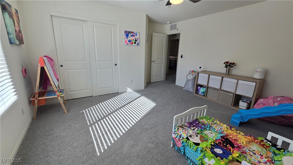 10971 Meridian Fields Avenue Las Vegas, NV 89166 - Photo 49 of 66 Bedroom featuring a closet, carpet floors, and a ceiling fan