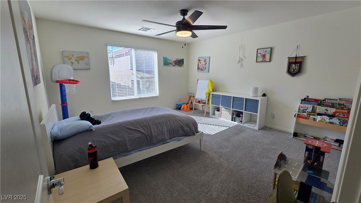 10971 Meridian Fields Avenue Las Vegas, NV 89166 - Photo 51 of 66 Carpeted bedroom featuring a ceiling fan and baseboards