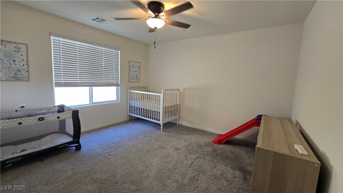 10971 Meridian Fields Avenue Las Vegas, NV 89166 - Photo 53 of 66 Bedroom with carpet, a ceiling fan, and a nursery area