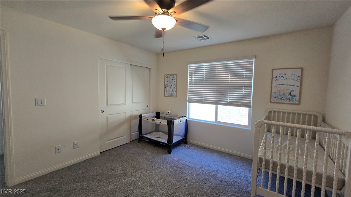 10971 Meridian Fields Avenue Las Vegas, NV 89166 - Photo 54 of 66 Bedroom with carpet floors, a ceiling fan, and a closet