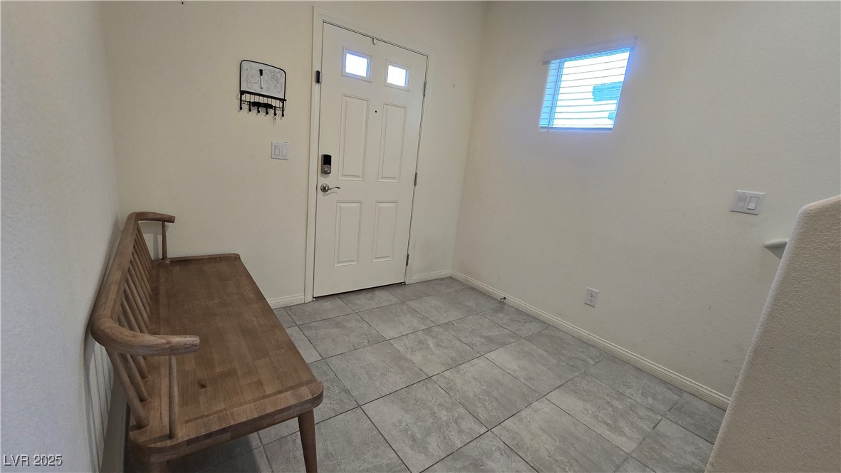 10971 Meridian Fields Avenue Las Vegas, NV 89166 - Photo 7 of 66 Foyer entrance featuring baseboards and light tile patterned flooring