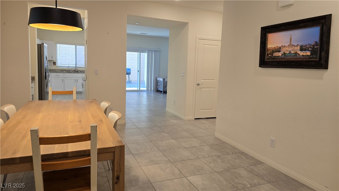 10971 Meridian Fields Avenue Las Vegas, NV 89166 - Photo 10 of 66 Dining room with light tile patterned floors and baseboards