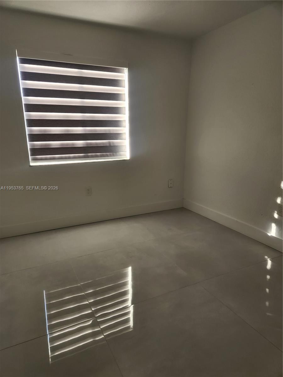 8025 Northwest 8th Street, Unit 10 Miami, FL 33126 - Photo 18 of 26 a view of room and window