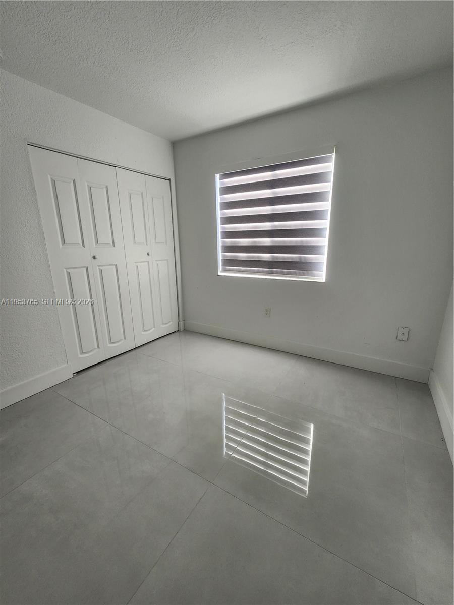 8025 Northwest 8th Street, Unit 10 Miami, FL 33126 - Photo 19 of 26 a view of an empty room with a window