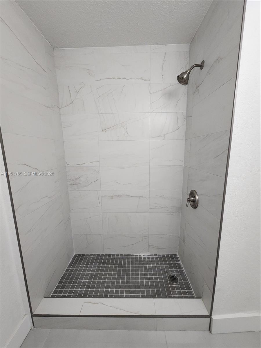 8025 Northwest 8th Street, Unit 10 Miami, FL 33126 - Photo 22 of 26 a bathroom with a glass door shower