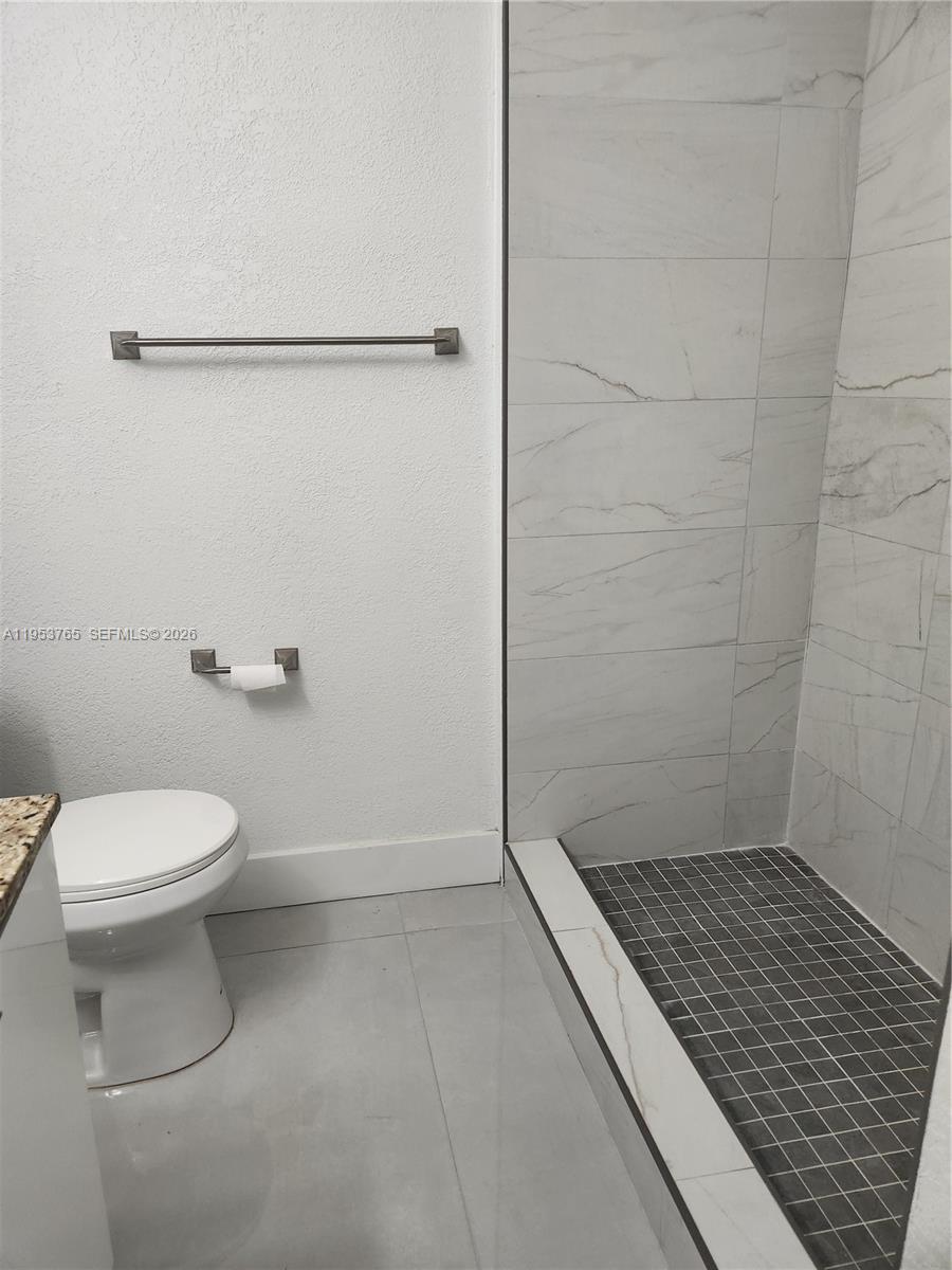 8025 Northwest 8th Street, Unit 10 Miami, FL 33126 - Photo 23 of 26 a bathroom with a toilet and a shower