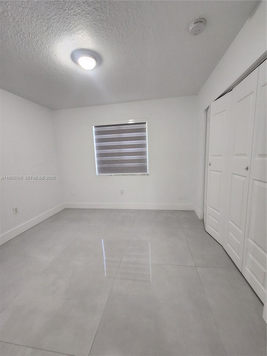 8025 Northwest 8th Street, Unit 10 Miami, FL 33126 - Photo 24 of 26 a view of an empty room with a window