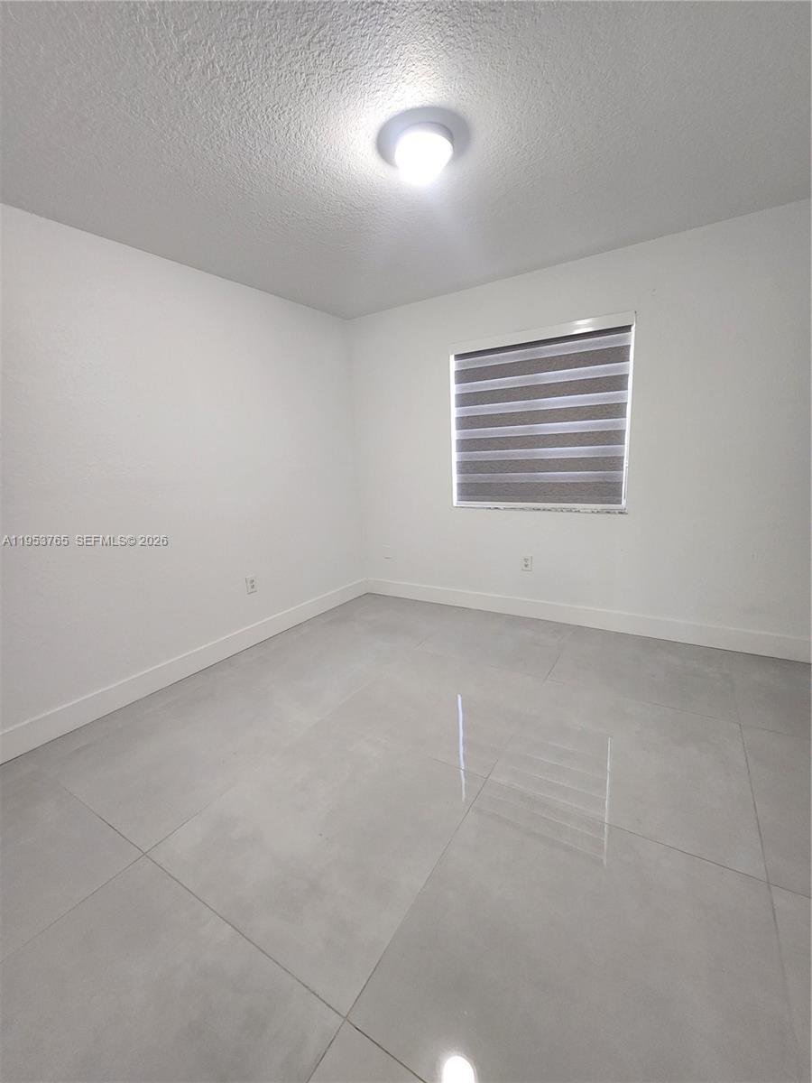8025 Northwest 8th Street, Unit 10 Miami, FL 33126 - Photo 25 of 26 an empty room with a window