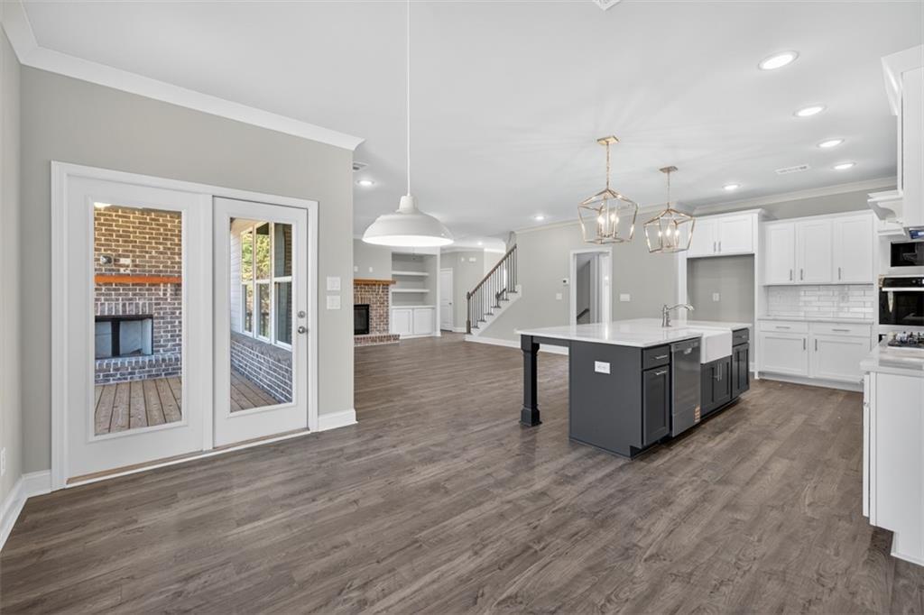 8845 Jot Em Down Road Gainesville, GA 30506 - Photo 25 of 87 a large kitchen with stainless steel appliances kitchen island a large counter top and wooden floors