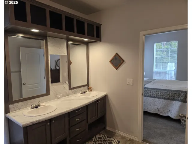 a en suite bathroom with a sink and mirror