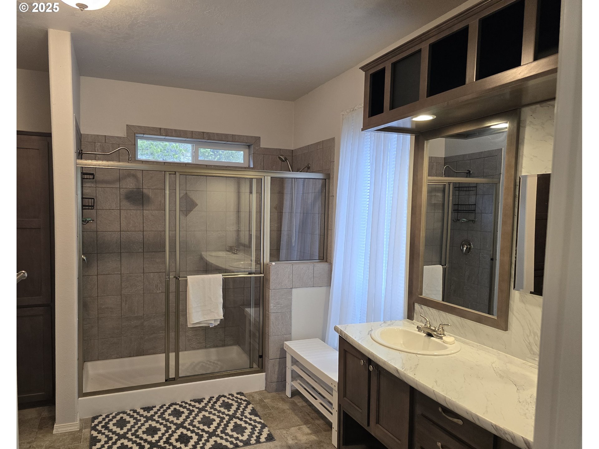 125220 Cappy Court Crescent Lake, OR 97733 - Photo 17 of 34 a bathroom with a shower a sink and mirror