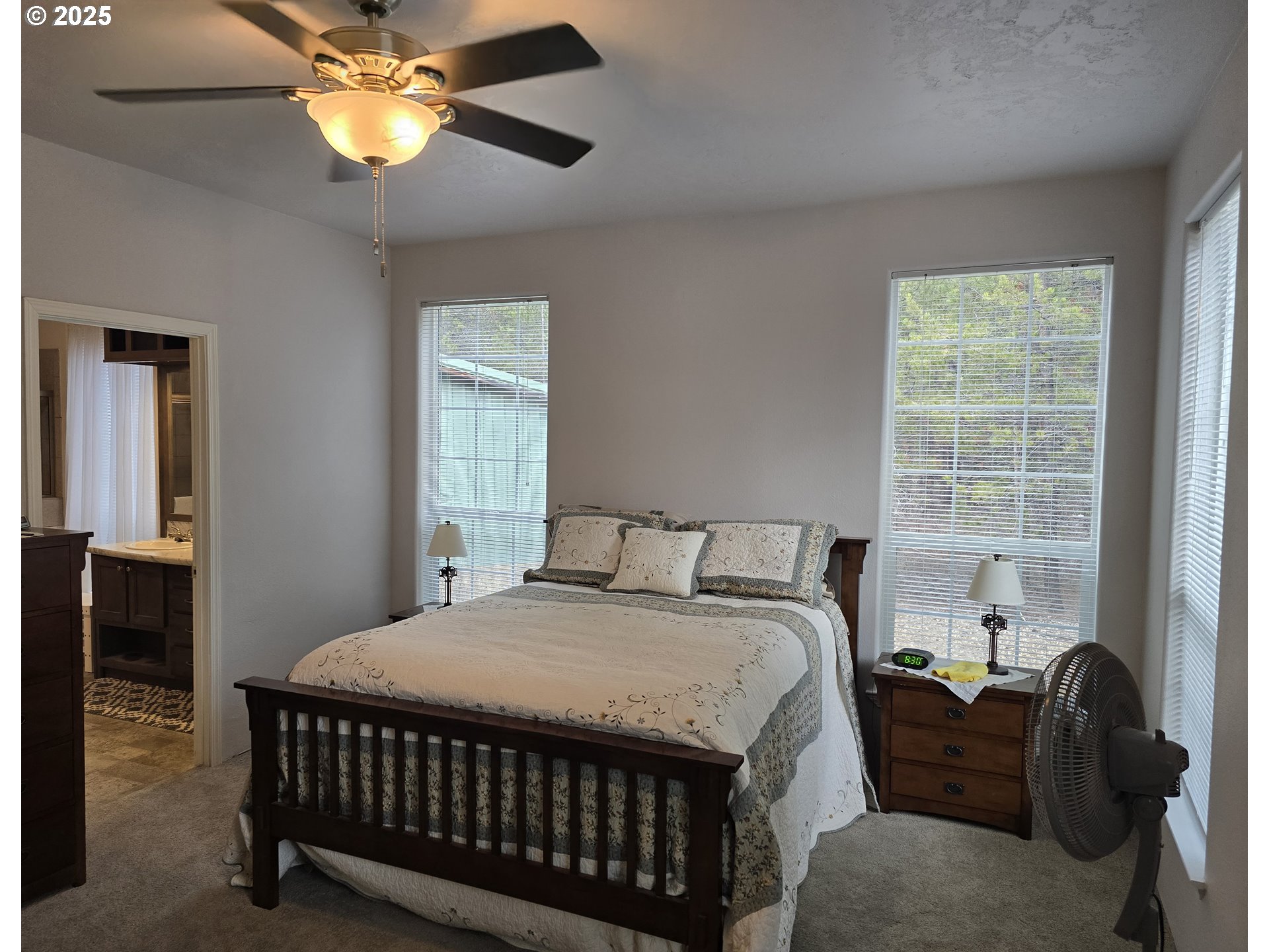 125220 Cappy Court Crescent Lake, OR 97733 - Photo 18 of 34 a bedroom with a bed and a chandelier