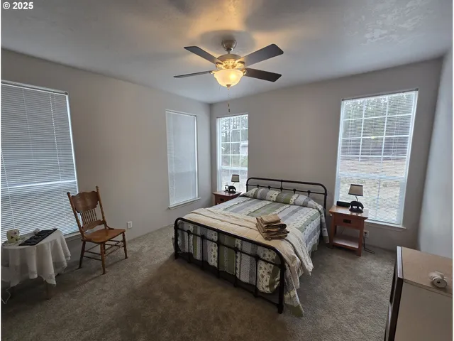 a bed sitting in a bedroom next to a window
