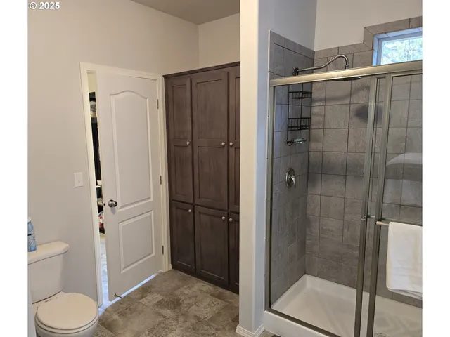 a bathroom with a shower and toilet