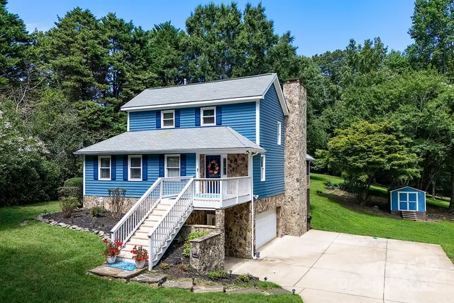 a front view of a house with a yard table and chairs