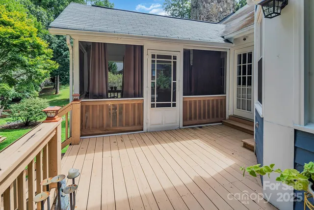 a view of backyard with deck and outdoor seating