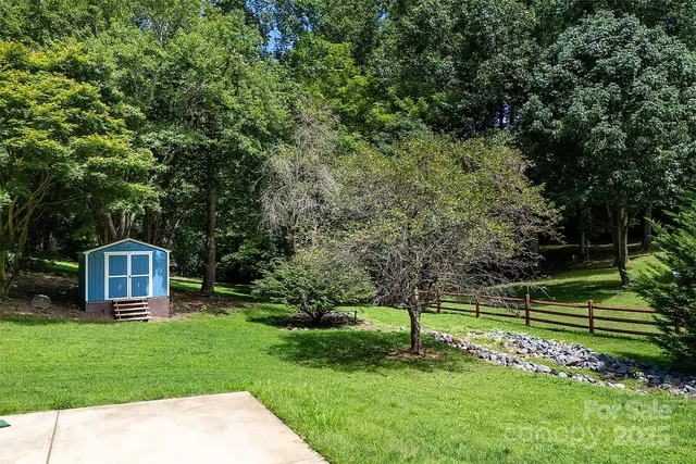 a view of a house with a yard and a garden