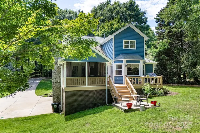 a front view of a house with a yard table and chairs