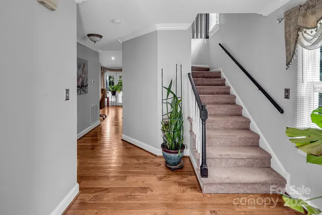 a view of entryway and hall with wooden floor
