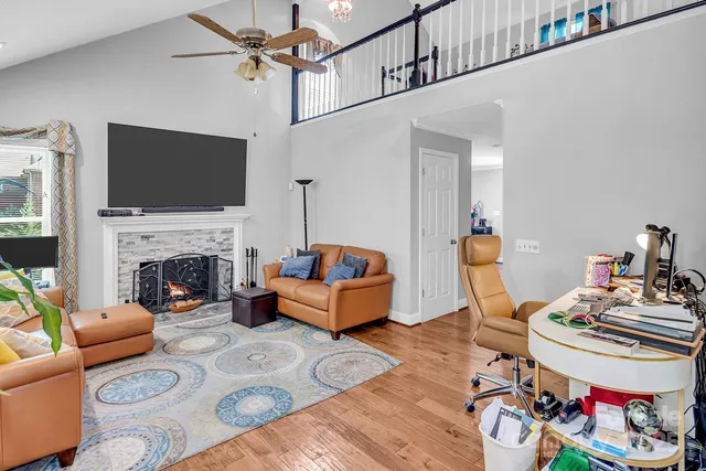 a living room with furniture fireplace and flat screen tv