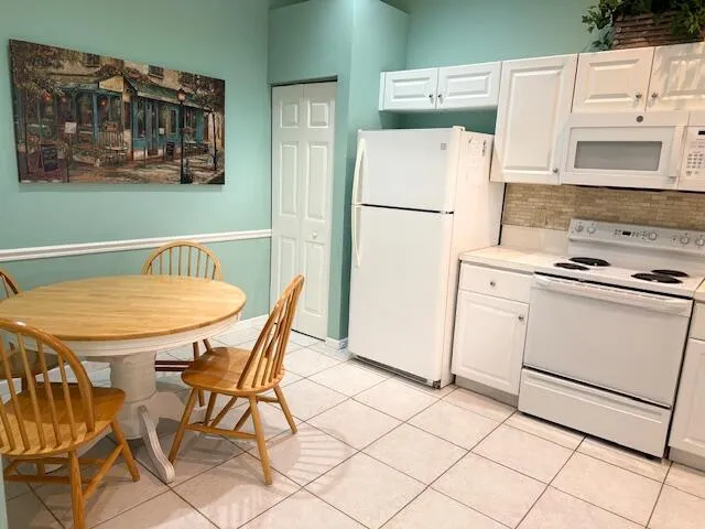 a kitchen with stainless steel appliances cabinets and table