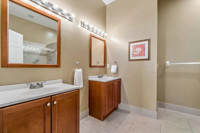 a bathroom with a sink mirror and a bathtub