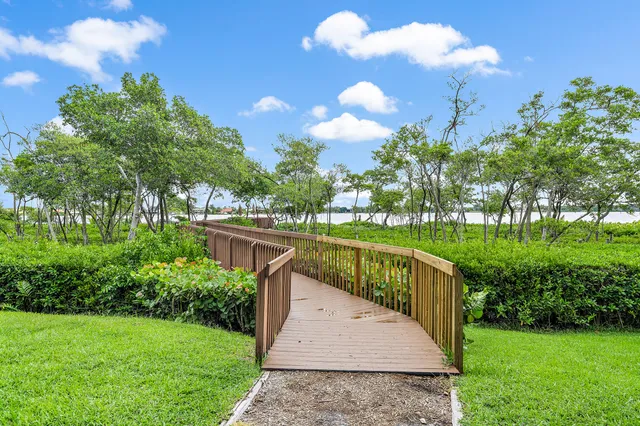 a view of a fountain in front of a house with a big yard