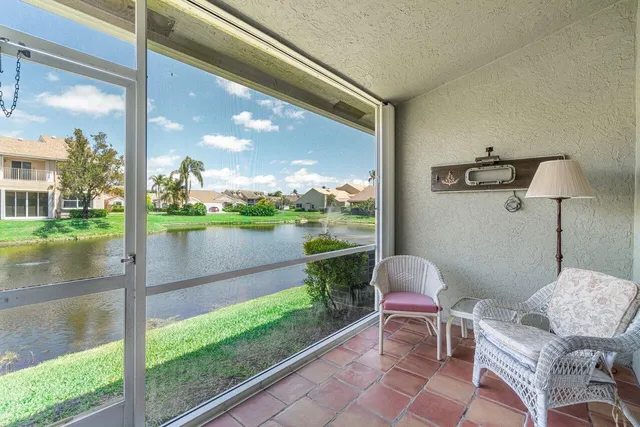 a balcony with table and chairs