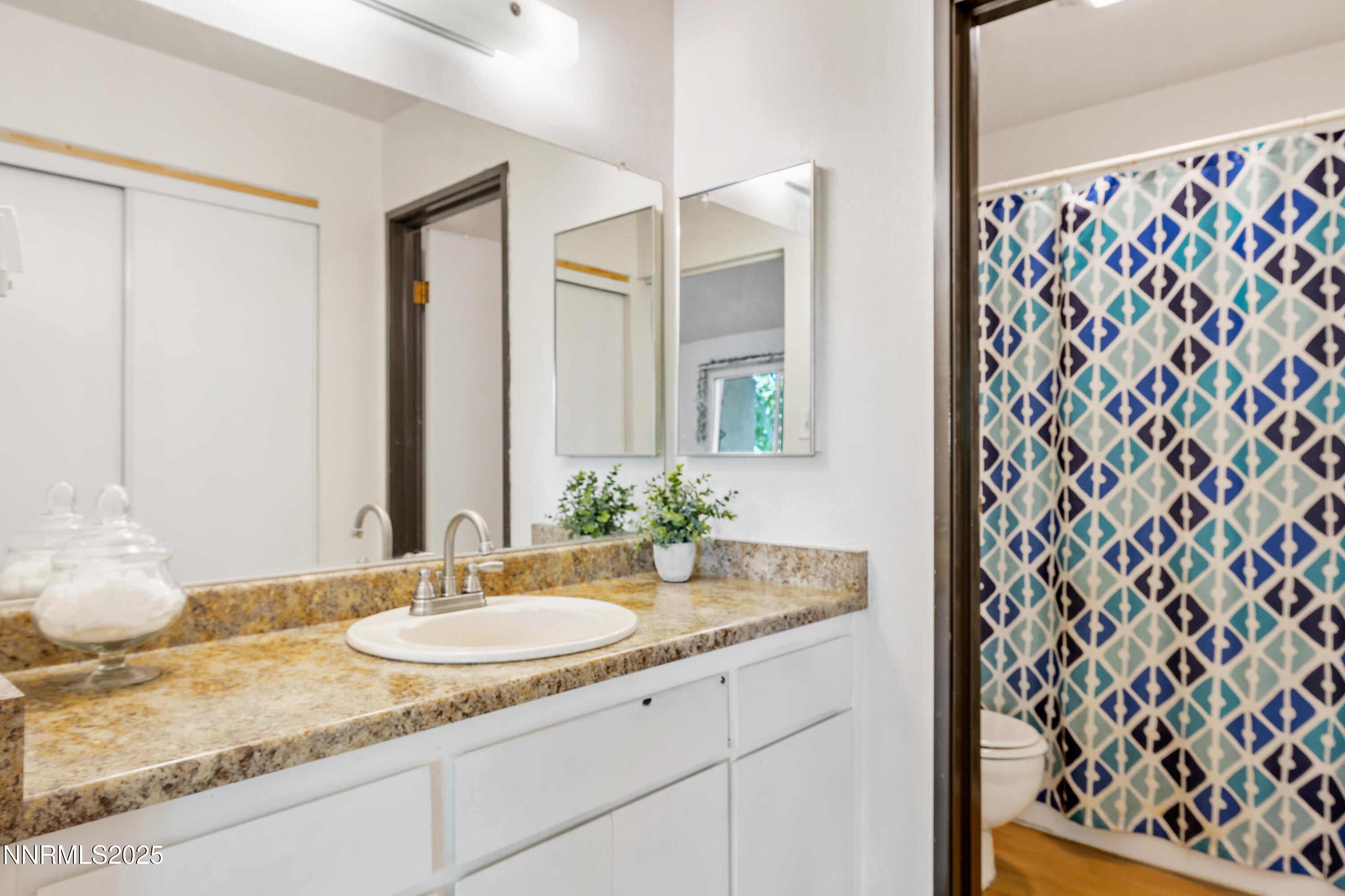 2450 Lymbery Street, Unit 307 Reno, NV 89509 - Photo 11 of 16 a bathroom with a granite countertop sink and a mirror