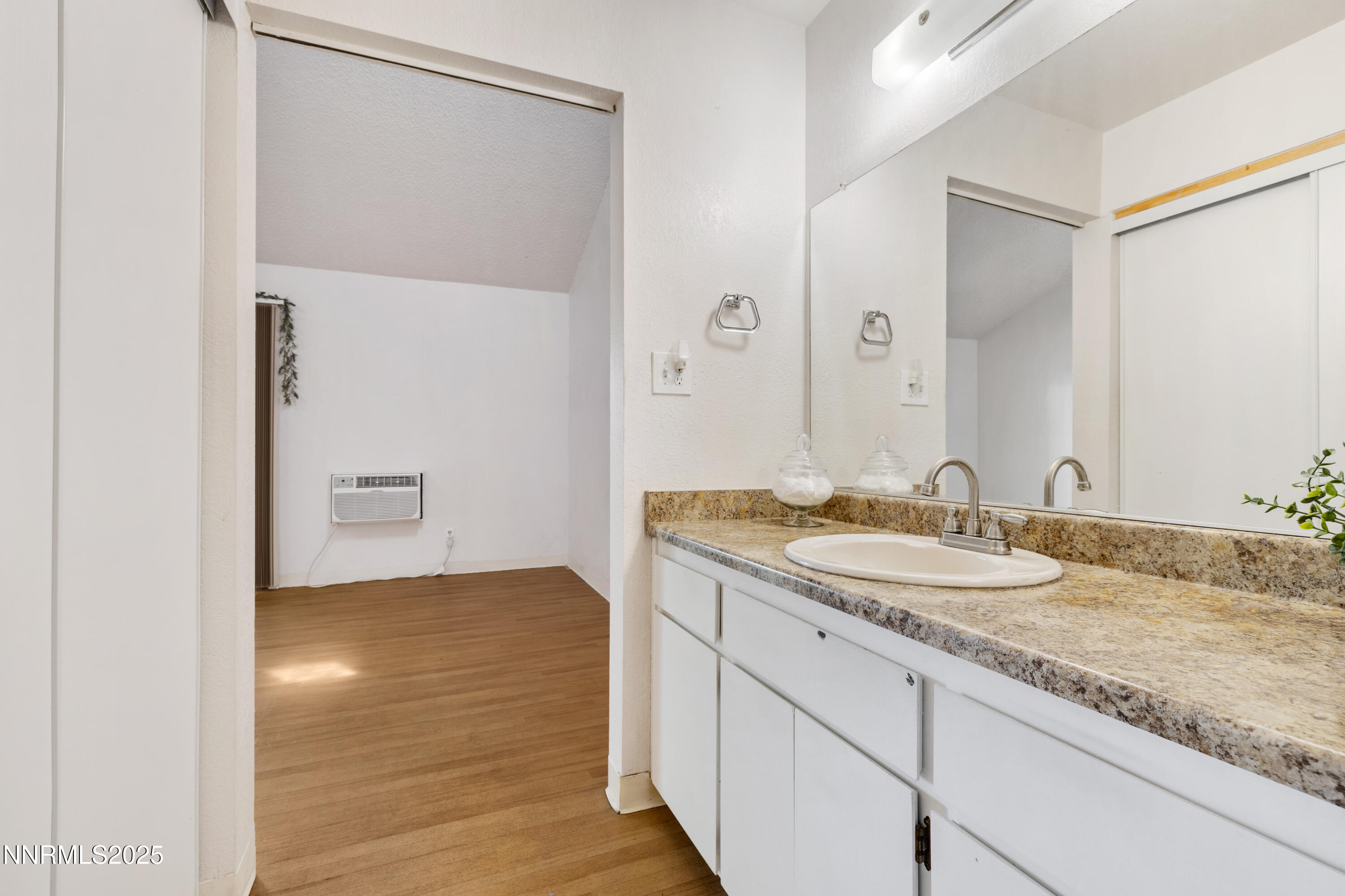 2450 Lymbery Street, Unit 307 Reno, NV 89509 - Photo 12 of 16 a bathroom with a granite countertop sink and a mirror