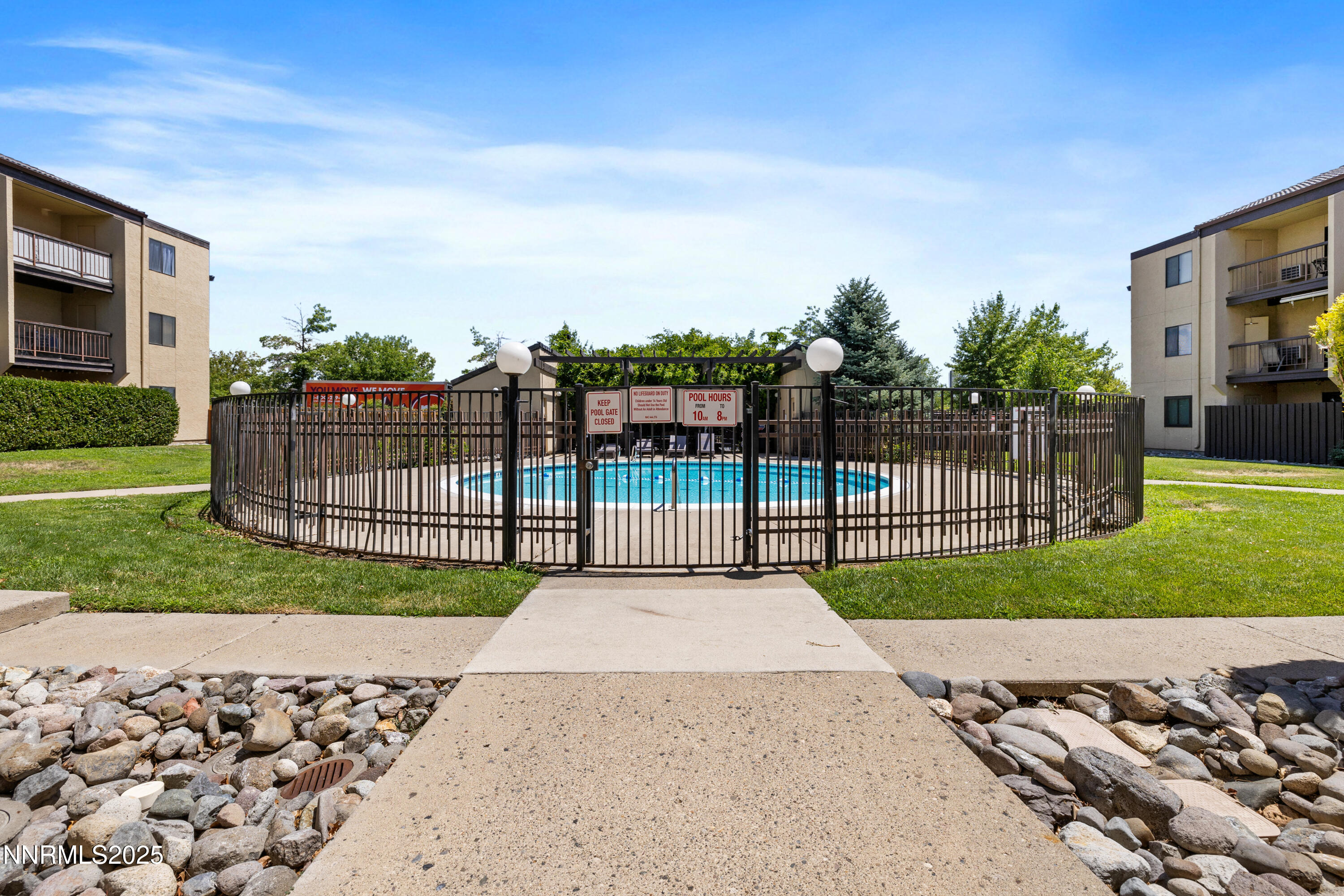 2450 Lymbery Street, Unit 307 Reno, NV 89509 - Photo 6 of 16 a view of a house with a small yard and a large tree
