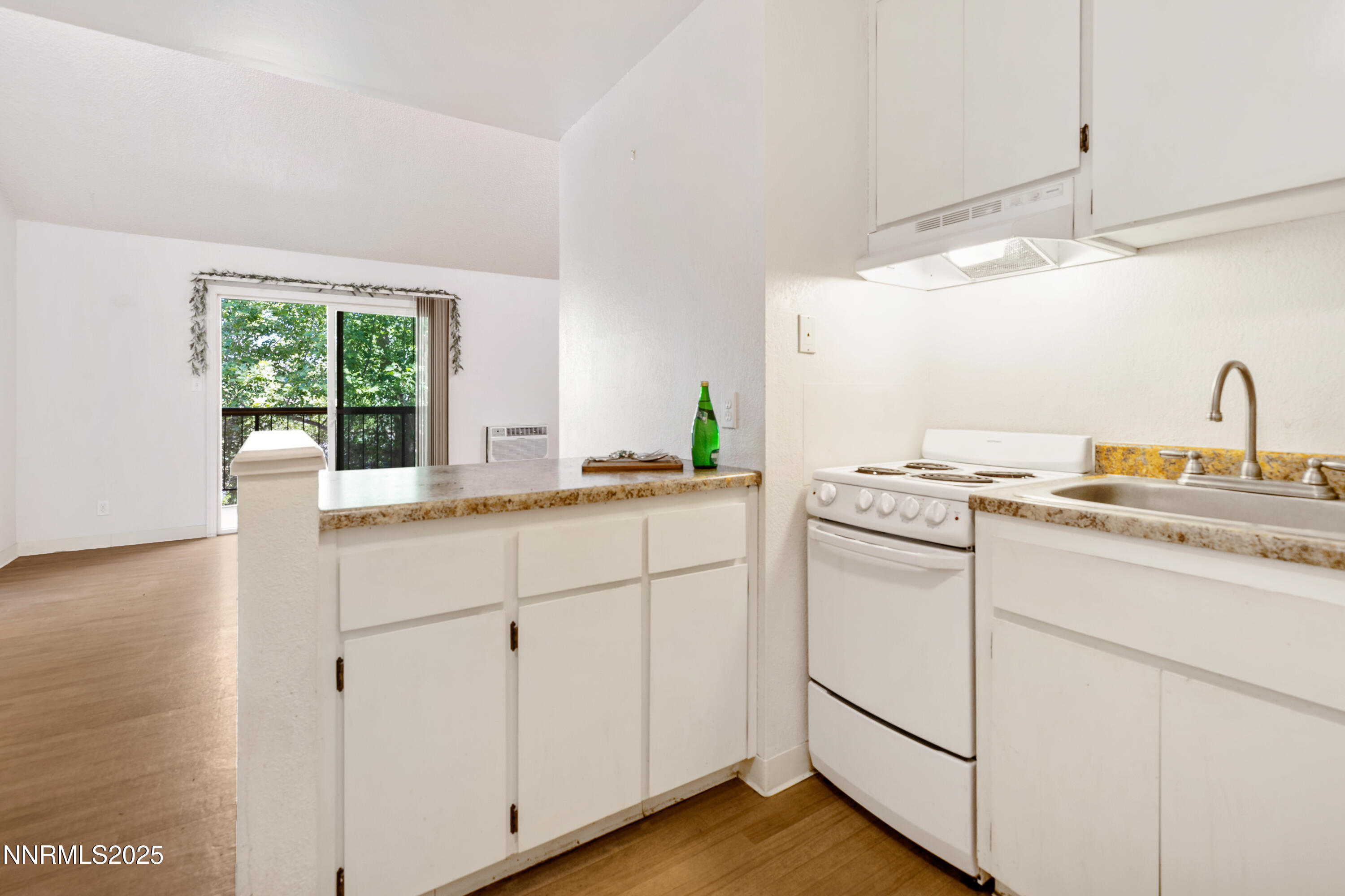 2450 Lymbery Street, Unit 307 Reno, NV 89509 - Photo 8 of 16 a kitchen with granite countertop white cabinets and white appliances