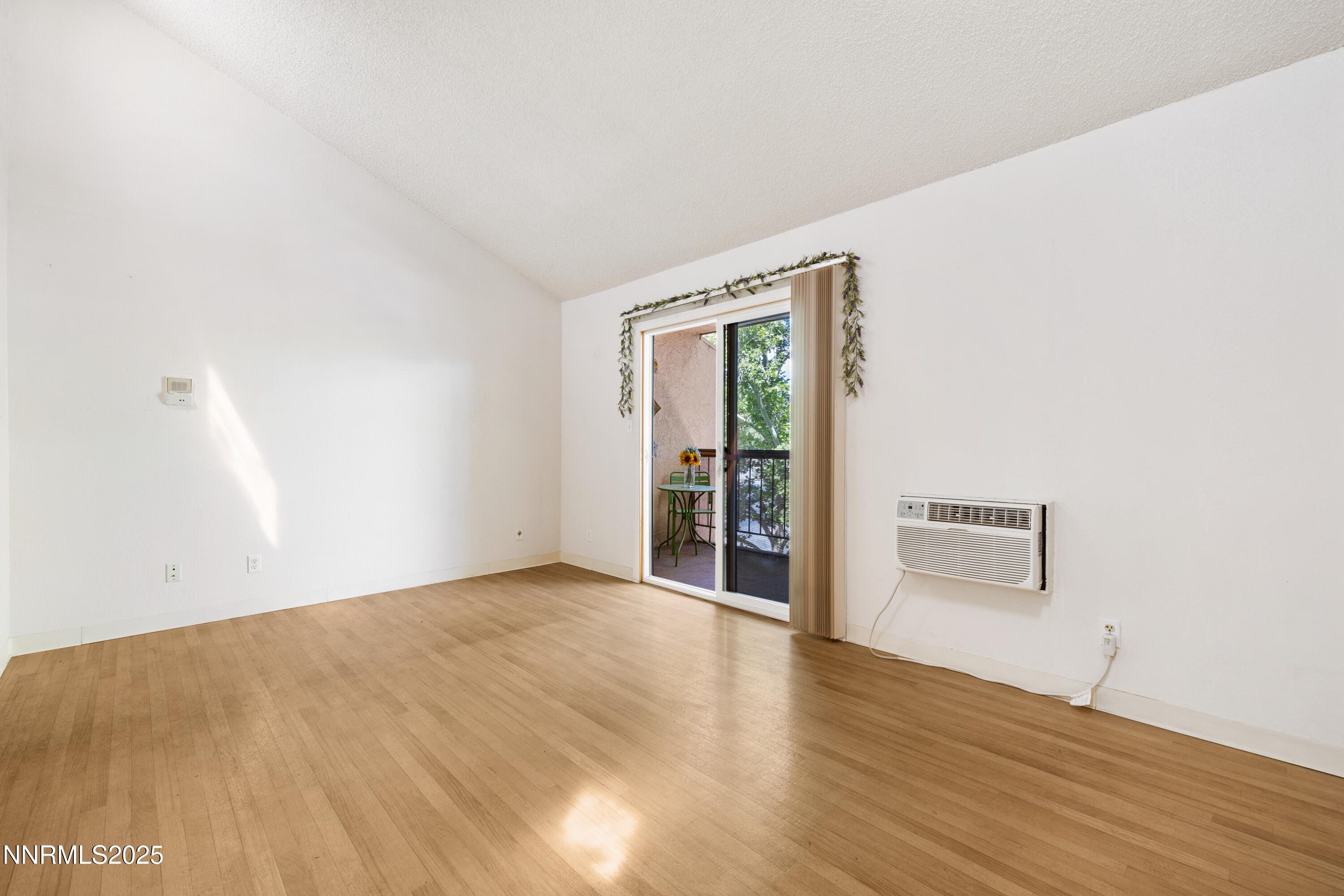 2450 Lymbery Street, Unit 307 Reno, NV 89509 - Photo 10 of 16 an empty room with wooden floor and windows