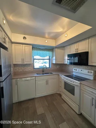a kitchen with stainless steel appliances granite countertop a stove and a sink