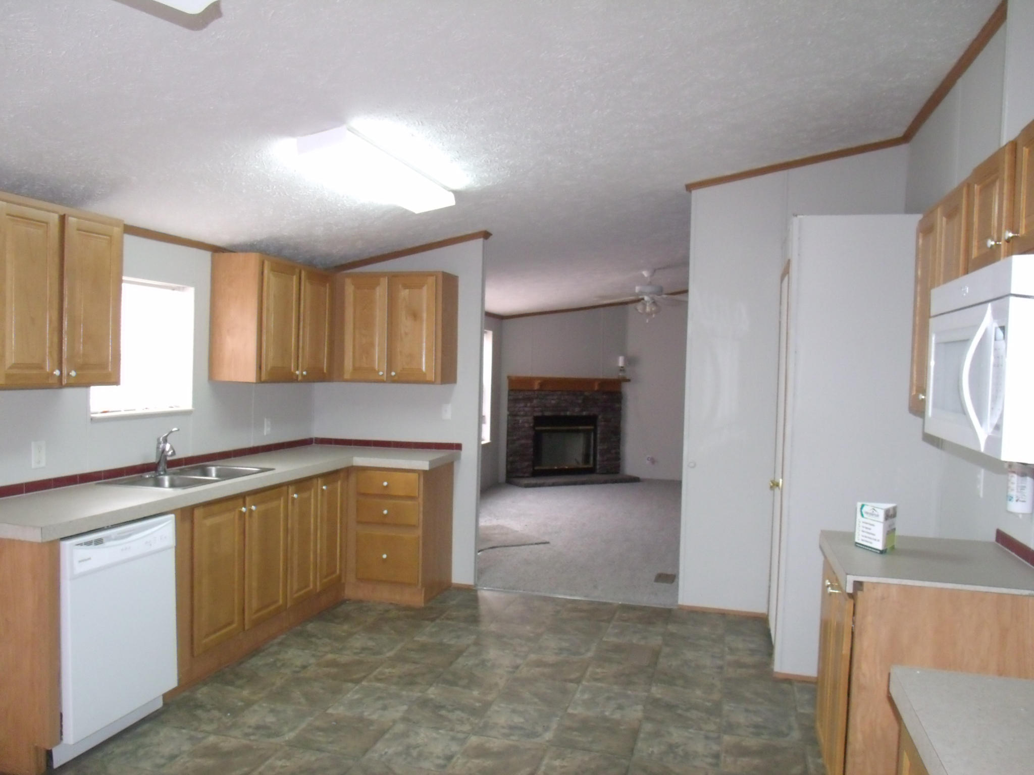 384 Kelly Mill Road Stuart, VA 24171 - Photo 9 of 15 a kitchen with a refrigerator and a sink