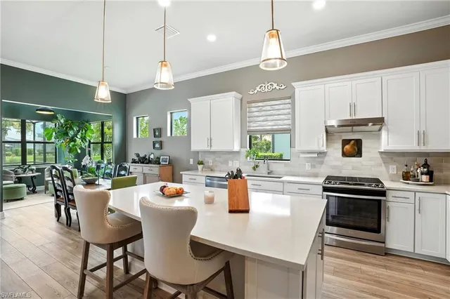 a kitchen with a table chairs stove and cabinets
